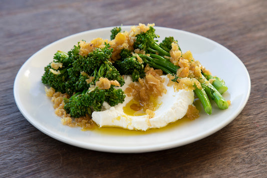 roasted crushed faba beans with cumin, lime, broccolini & labne