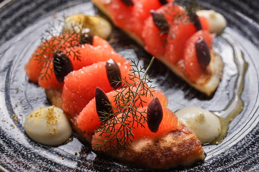 pan-fried halloumi with honey, ruby grapefruit, black olives and fennel puree